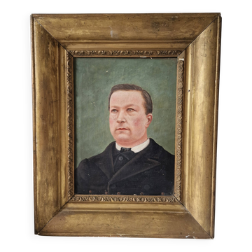 Old portrait of a man in a gilded frame