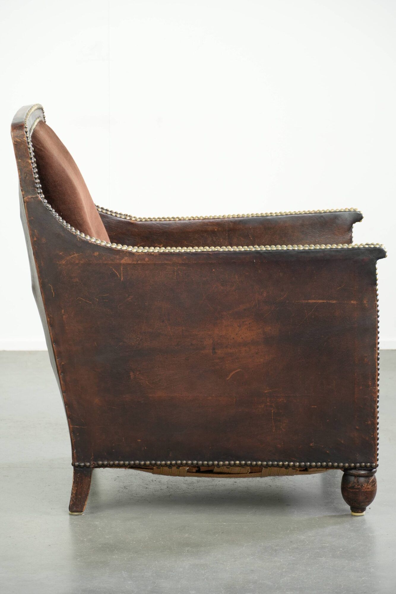 Art Deco design armchair finished in velvet and fitted with decorative nails