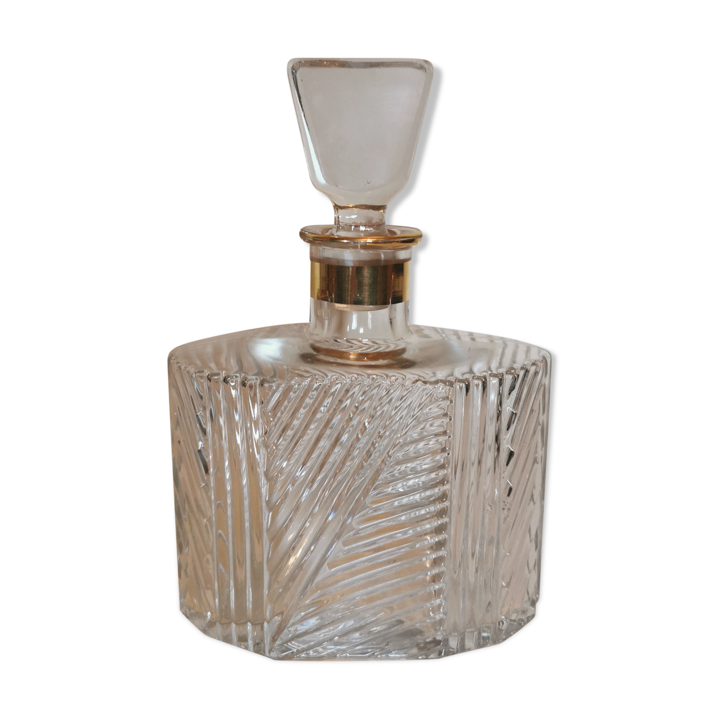 Carved glass decanter, golden band on the collar