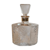 Cut glass carafe with a gold band on the neck.