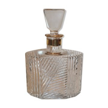 Cut glass carafe with a gold band on the neck.