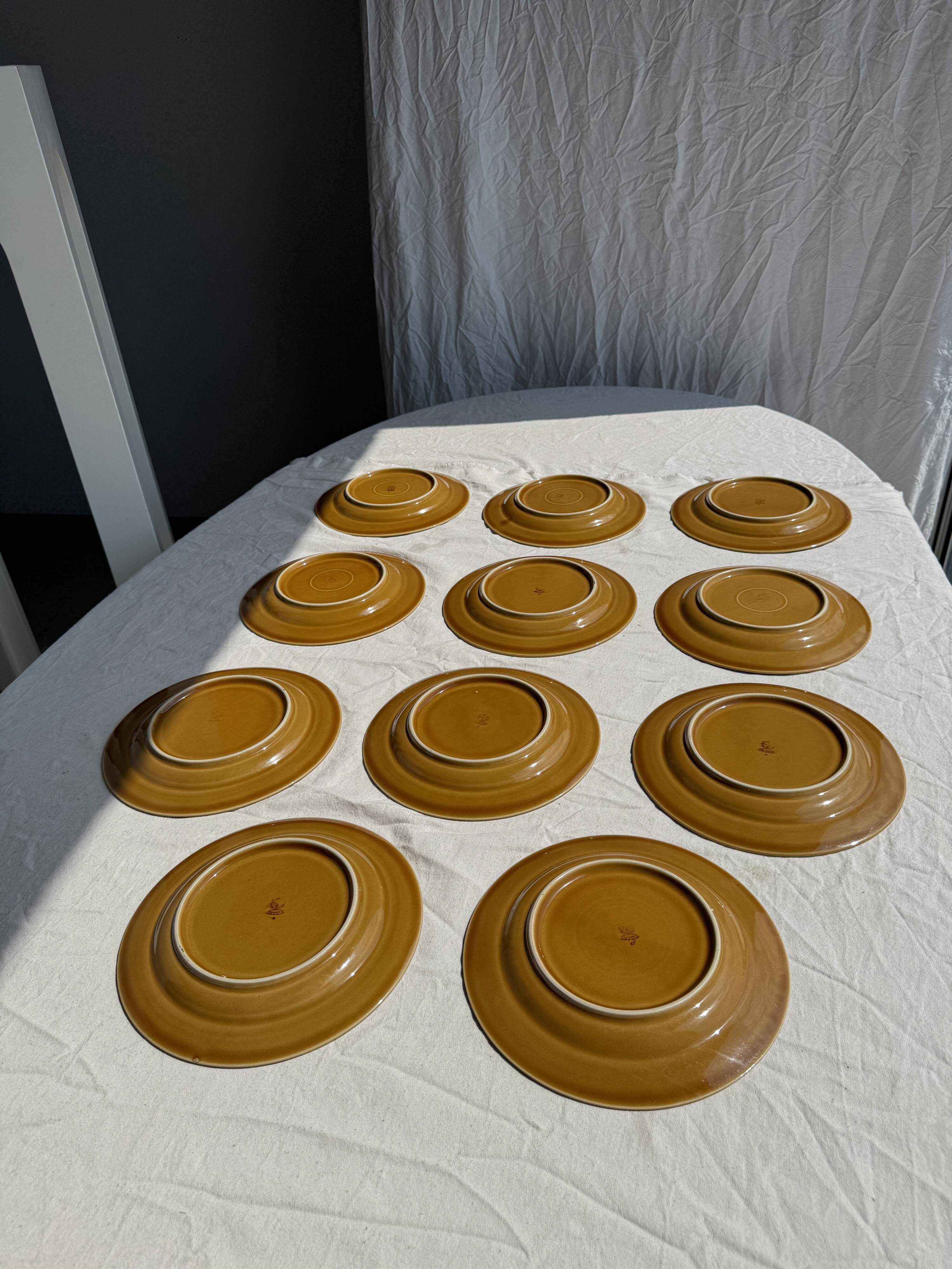 Set of 11 dark brown yellow stoneware plates D24