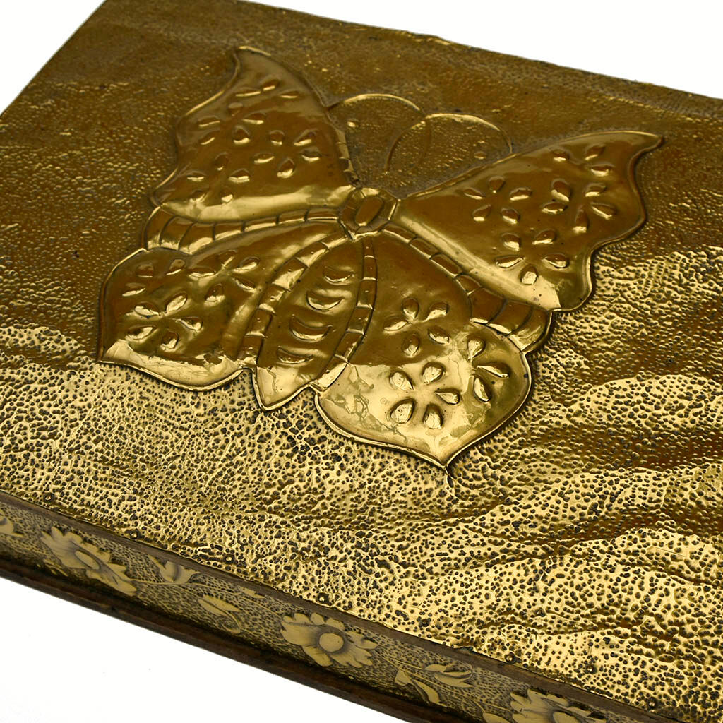 Old wooden box decorated with carved gold metal repelled vintage butterfly