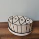 Vintage artisanal rustic ceramic butter dish with geometric eye pattern
