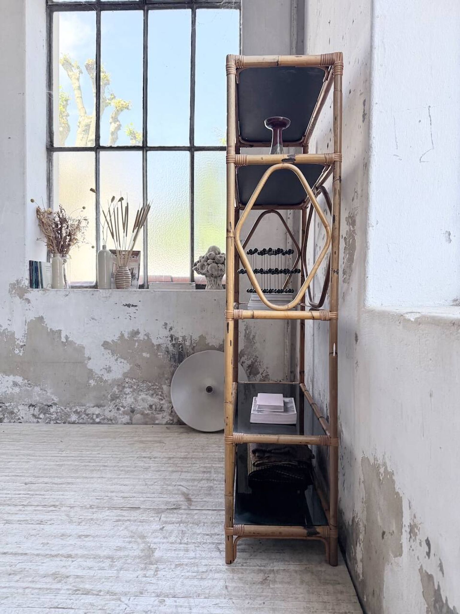 Rattan bookshelf and black glasses