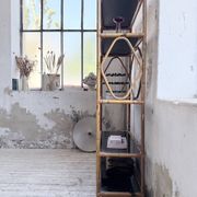 Rattan bookshelf and black glasses