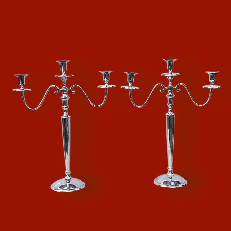 Pair of vintage three-armed chrome metal candlesticks
