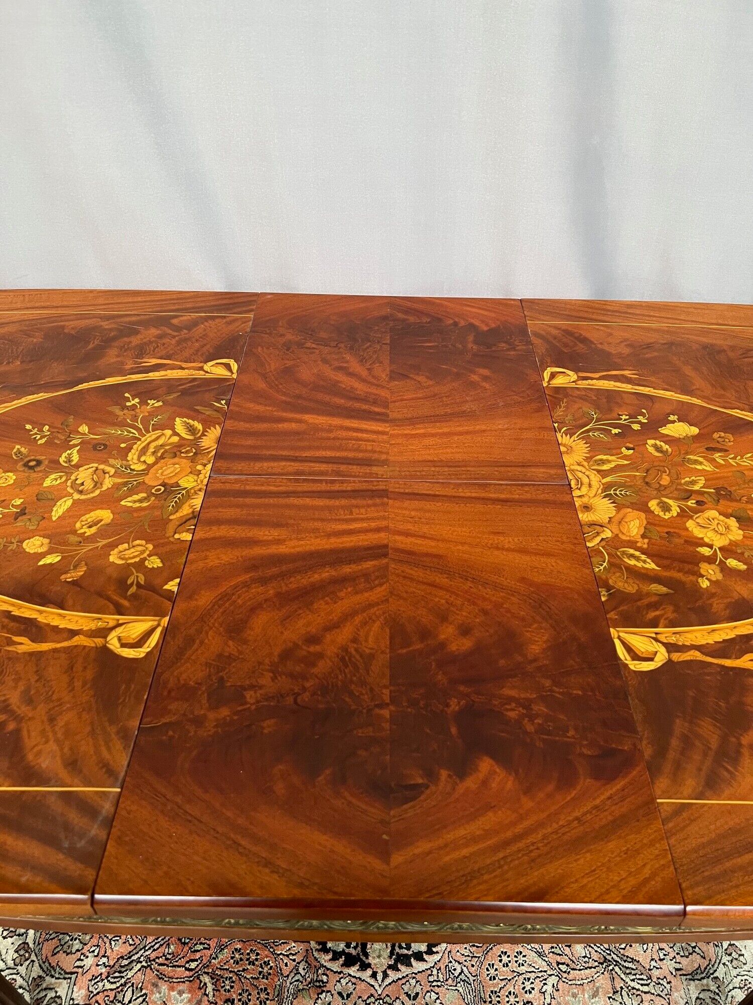 Louis XVI style oval dining table with rosewood marquetry extension mounted in bronze