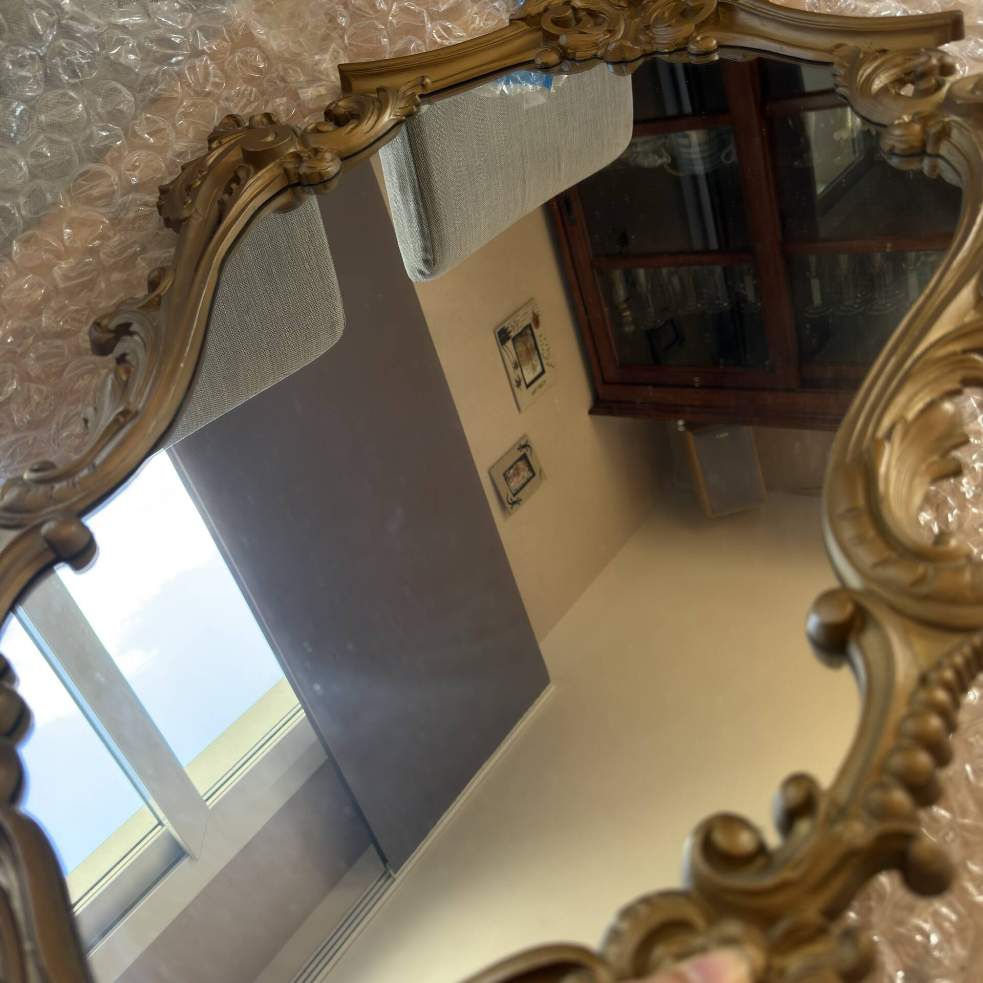 Antique mirror in Louis XV Rocaille style with carved frame.