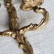 Vintage wall sconce in gold metal with two arms in classic style.