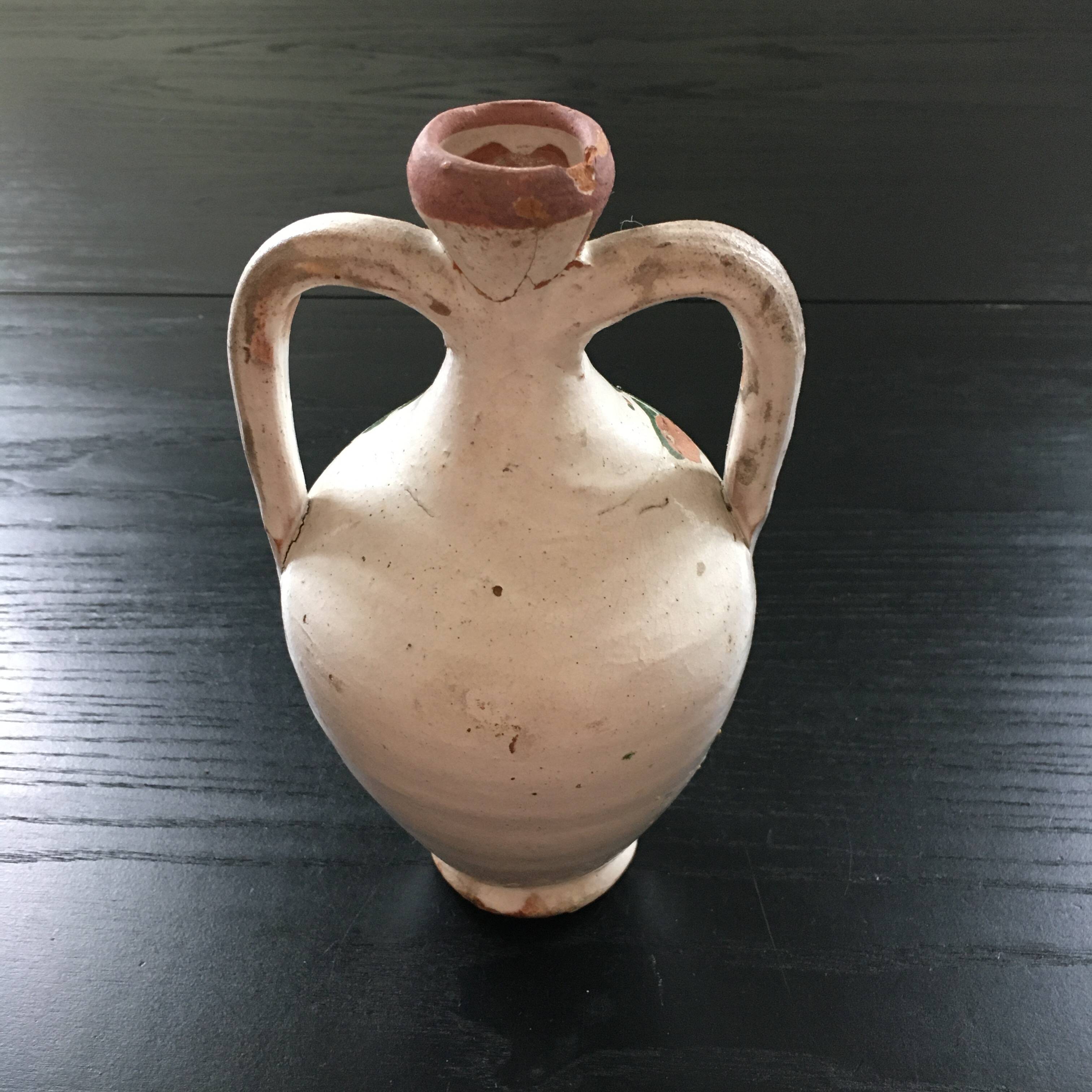 Small old amphora with floral decoration