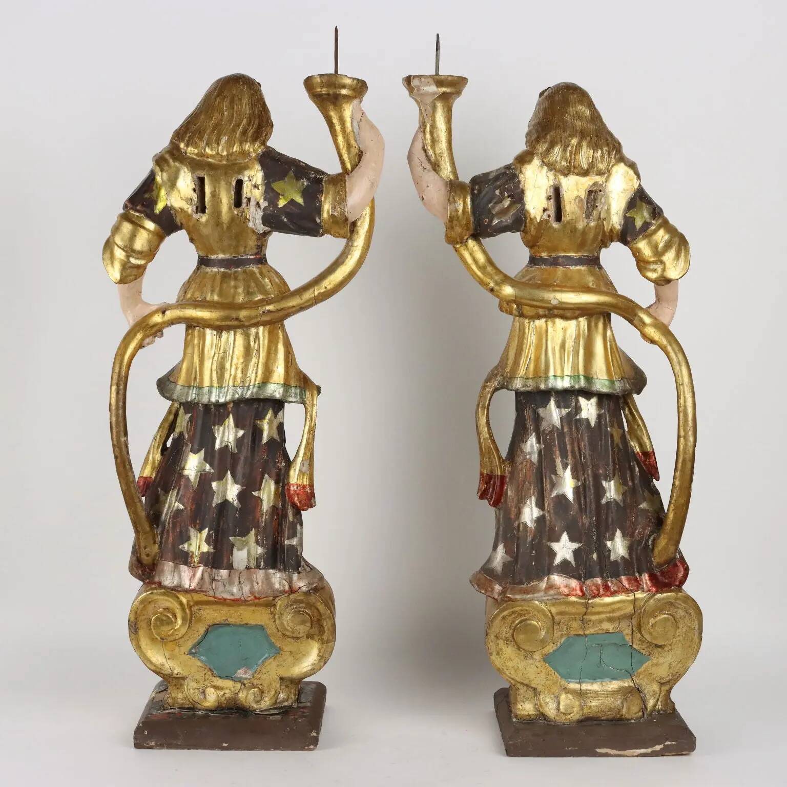 Antique wooden lacquered angel-shaped candlesticks, 18th century.