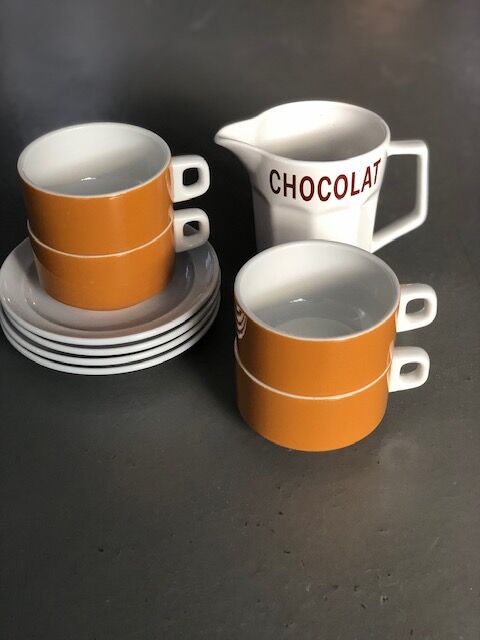 Hot chocolate cups and milk jar