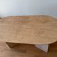 Oblong dining table in beige travertine.