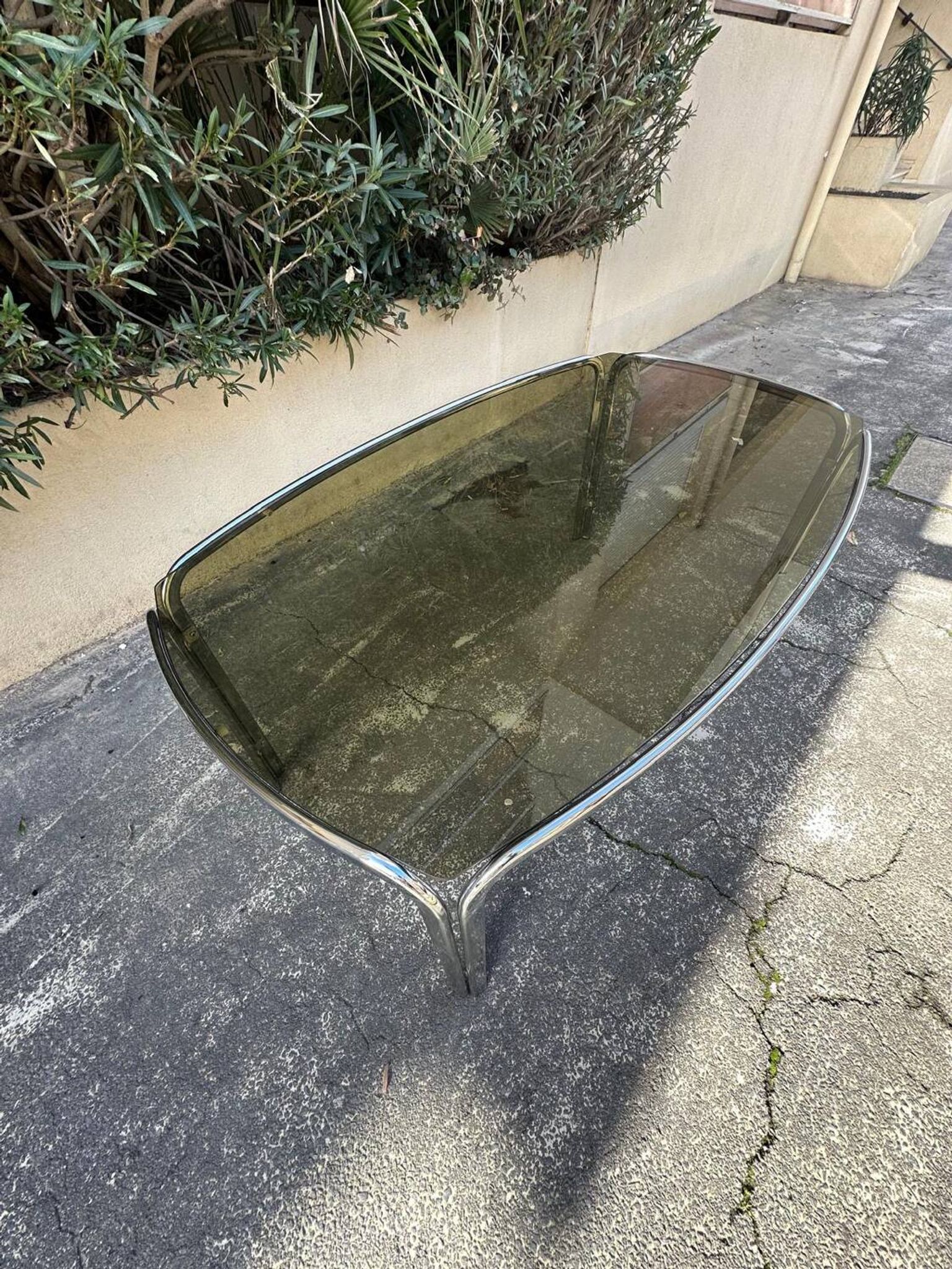 Vintage curved rectangular dining table in smoked glass and metal.