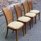 Four 20th-century Directoire-style chairs in solid wood with cane seats and beige fabric