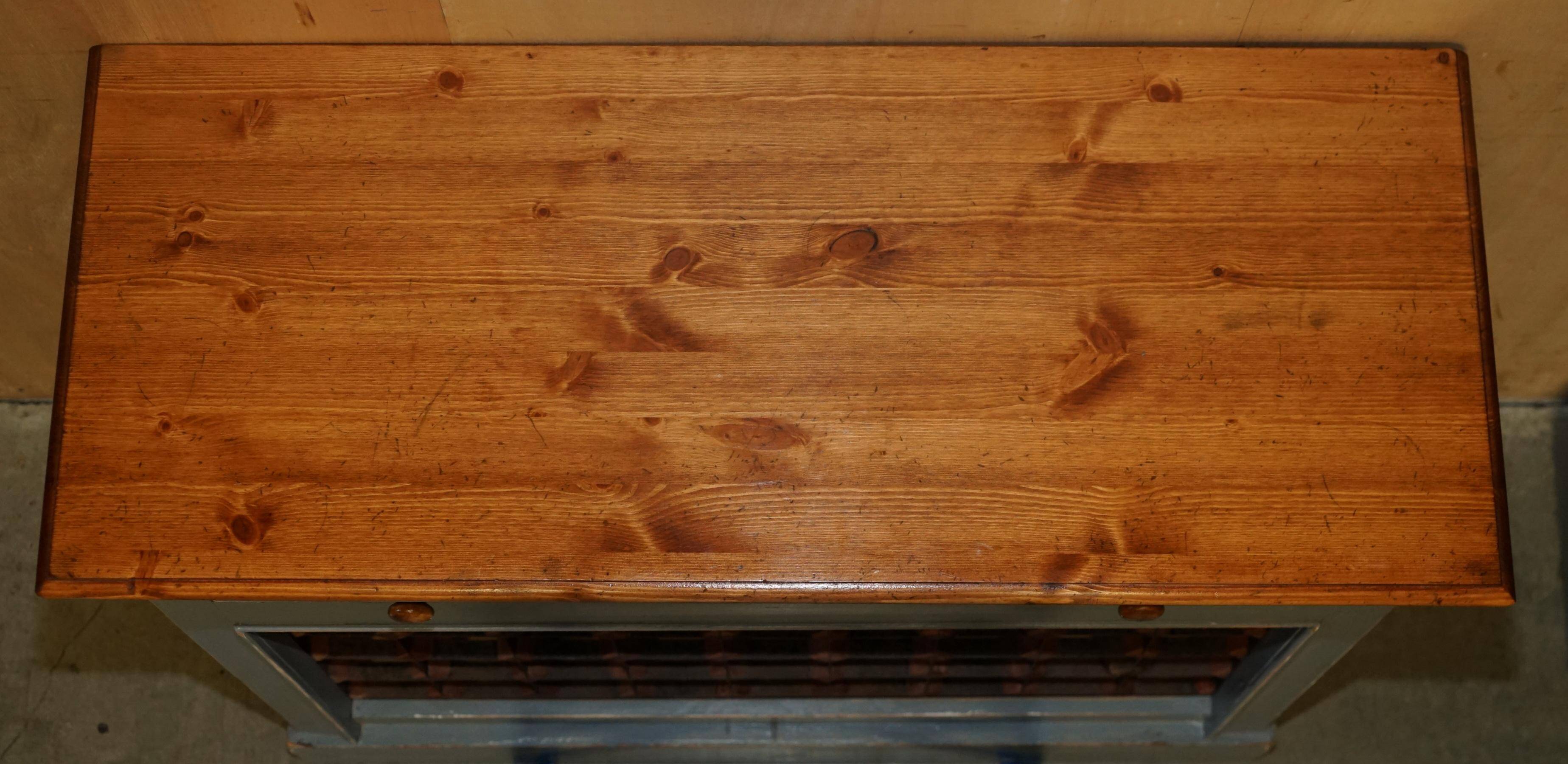 Vintage wooden furniture for 45 wine bottles with a drawer.