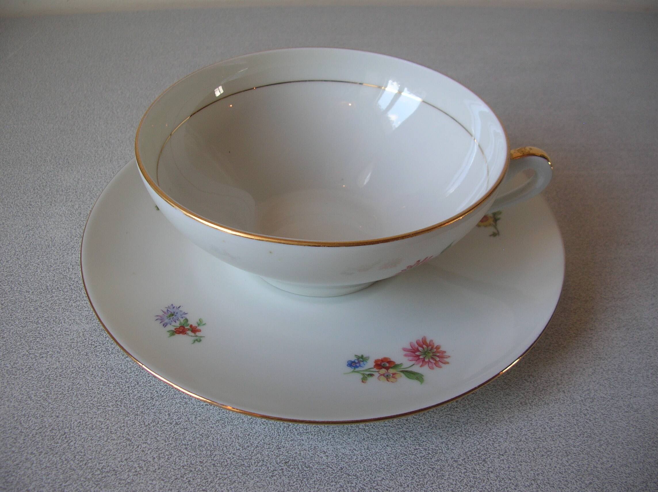 Old large tea cup and saucer in Limoges porcelain with flower decor