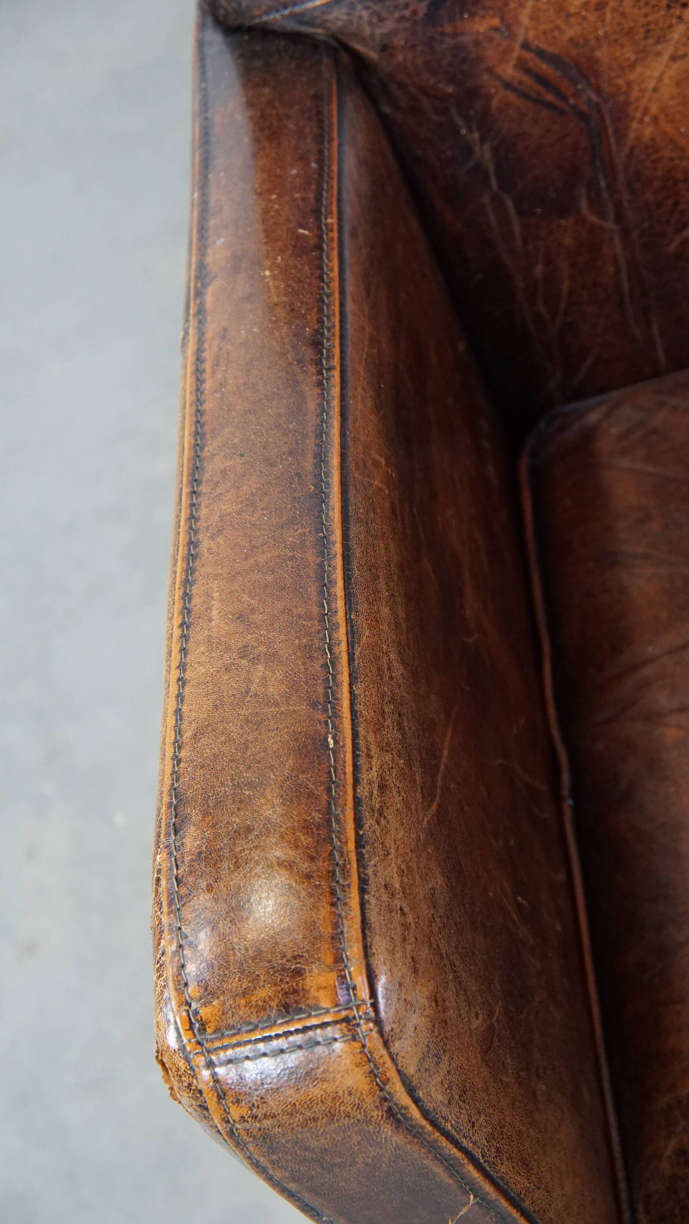 Dark brown design armchair made of sheepskin leather