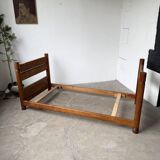 Brutalist style bed with chain and straw