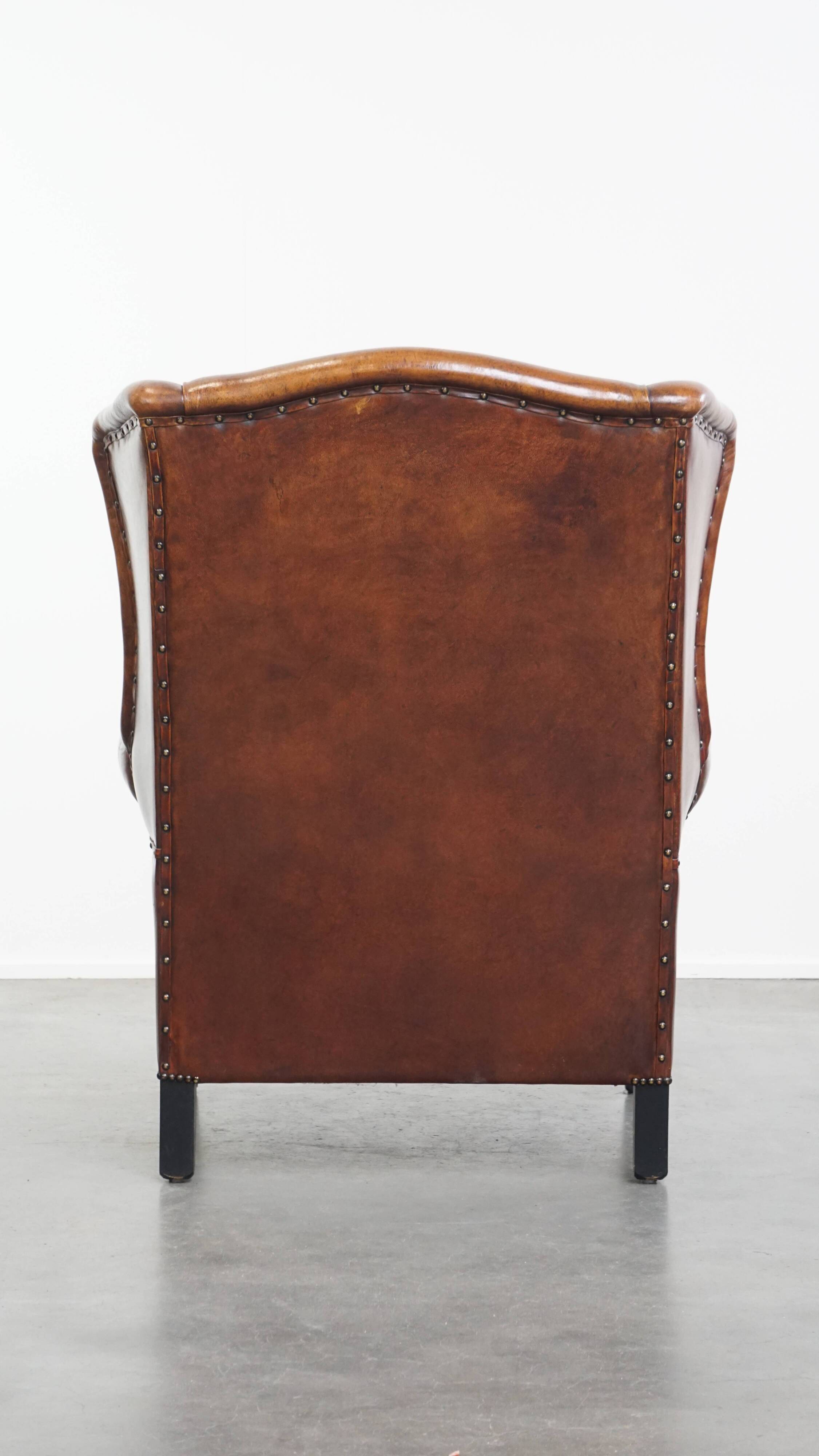 Sheepskin Wingback Chair with Warm Tones and Black Piping