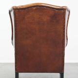 Sheepskin Wingback Chair with Warm Tones and Black Piping