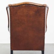 Sheepskin Wingback Chair with Warm Tones and Black Piping