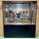 Store window with sliding doors in matte black patinated oak - 30s
