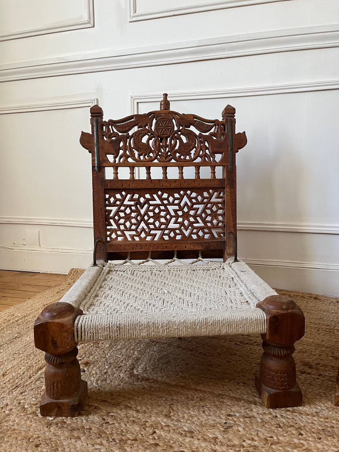 Pair of traditional Indian chairs made of carved wood and rope
