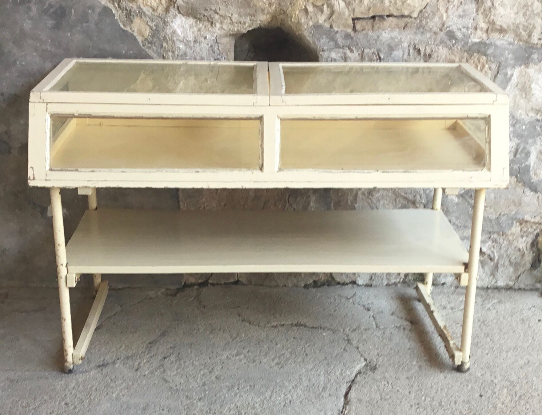 Old showcase on tubular metal feet - early twentieth century