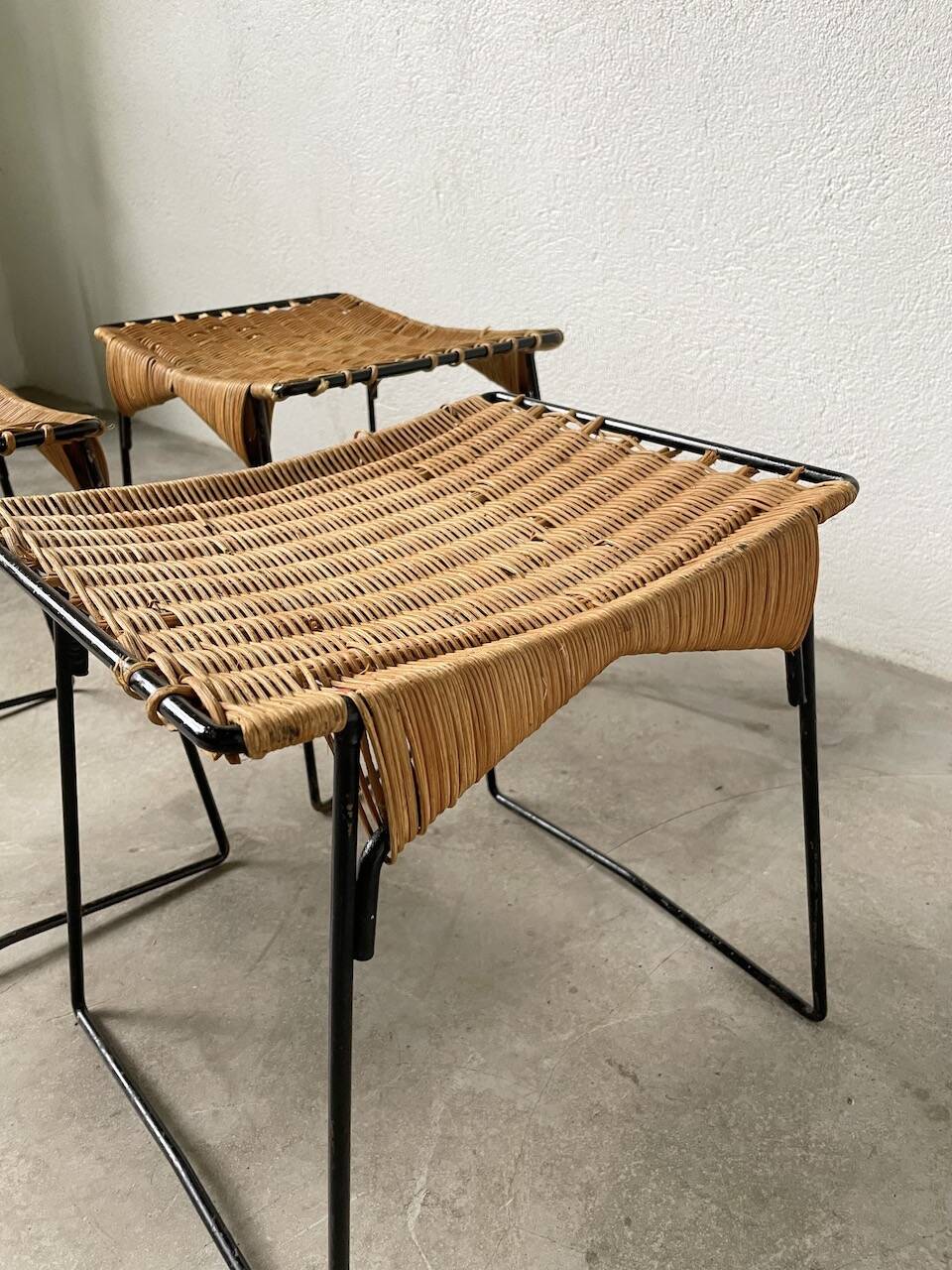 Set of three Raoul Guys wicker and metal stools