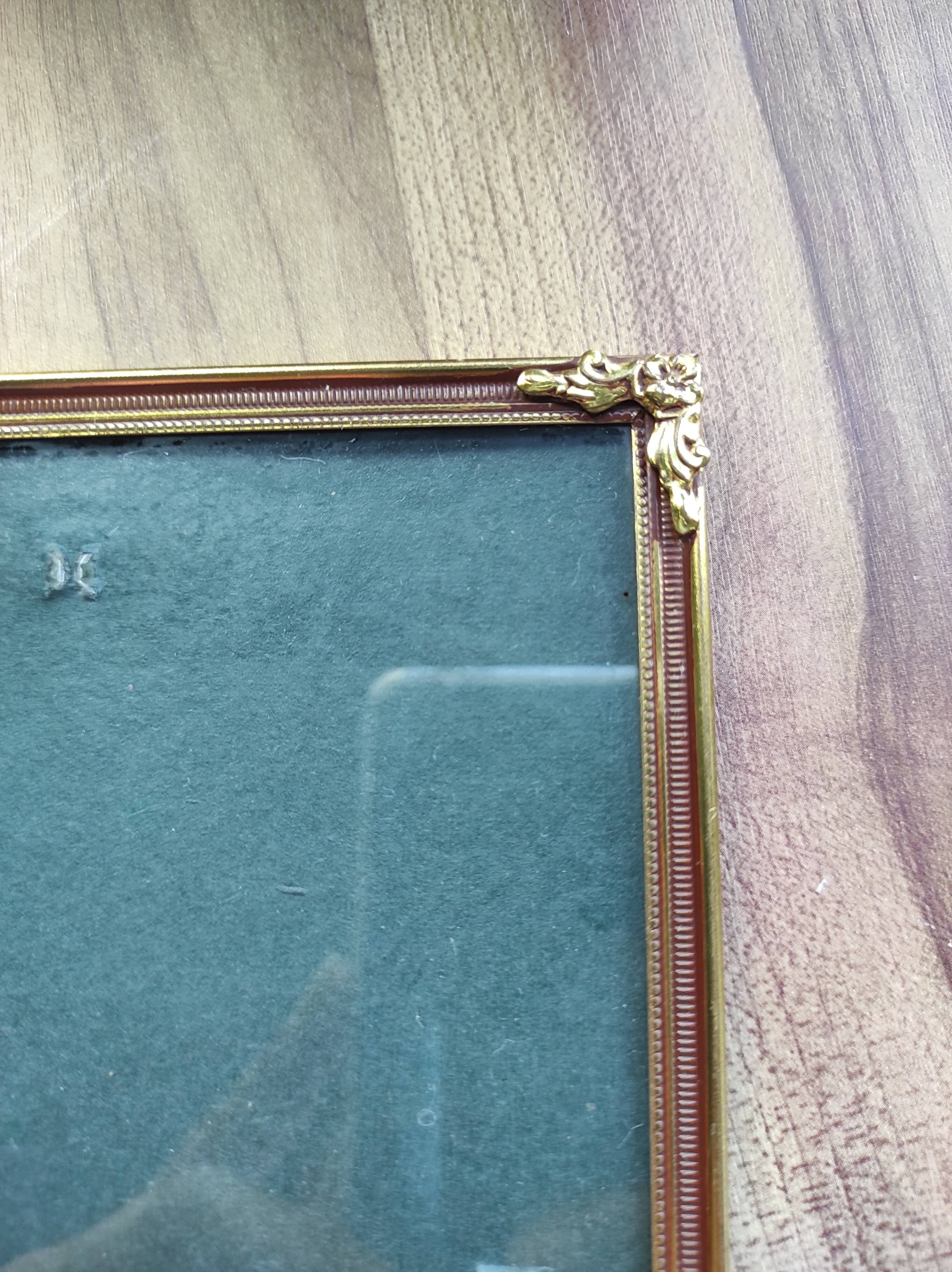 Vintage photo frame in gold and decorated metal