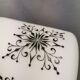 Scandinavian hanging lamp in white glass with inlayed black motifs.
