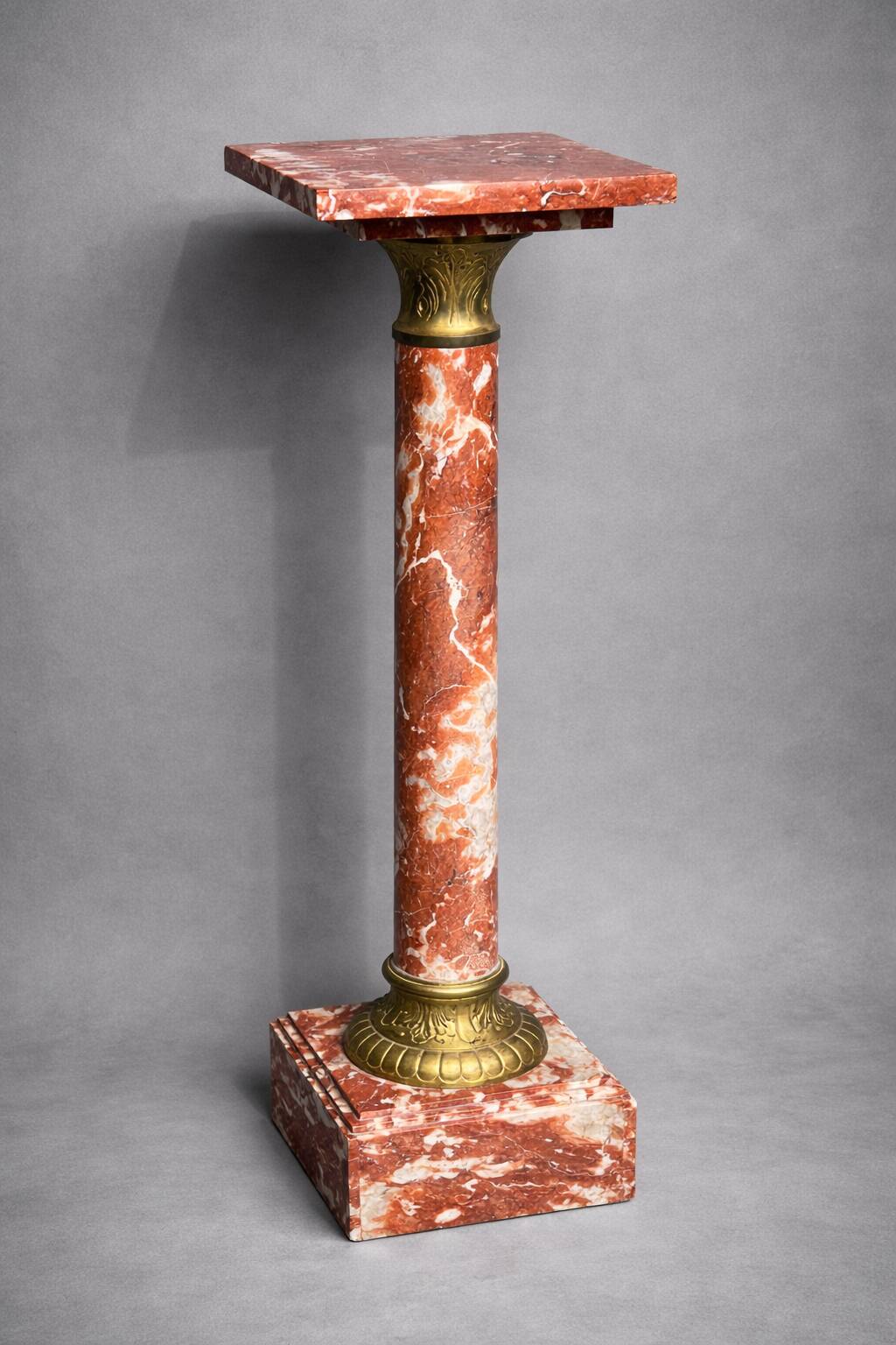 Marble pedestal decorated with gilded brass.