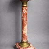 Marble pedestal decorated with gilded brass.