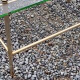 Vintage coffee table in gold and blackened metal with glass top from the 60s