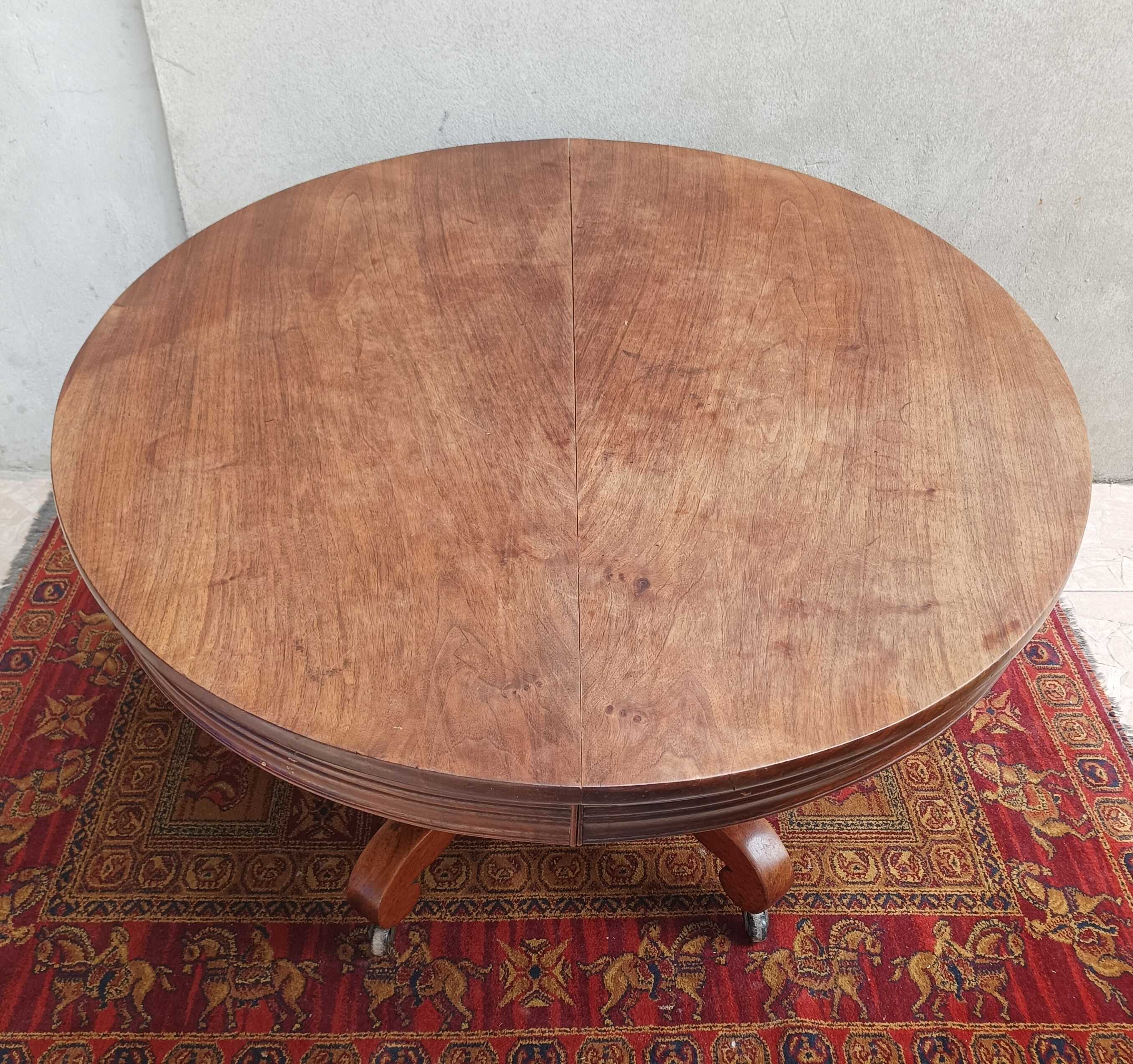 English oval table with 19th century mahogany extensions