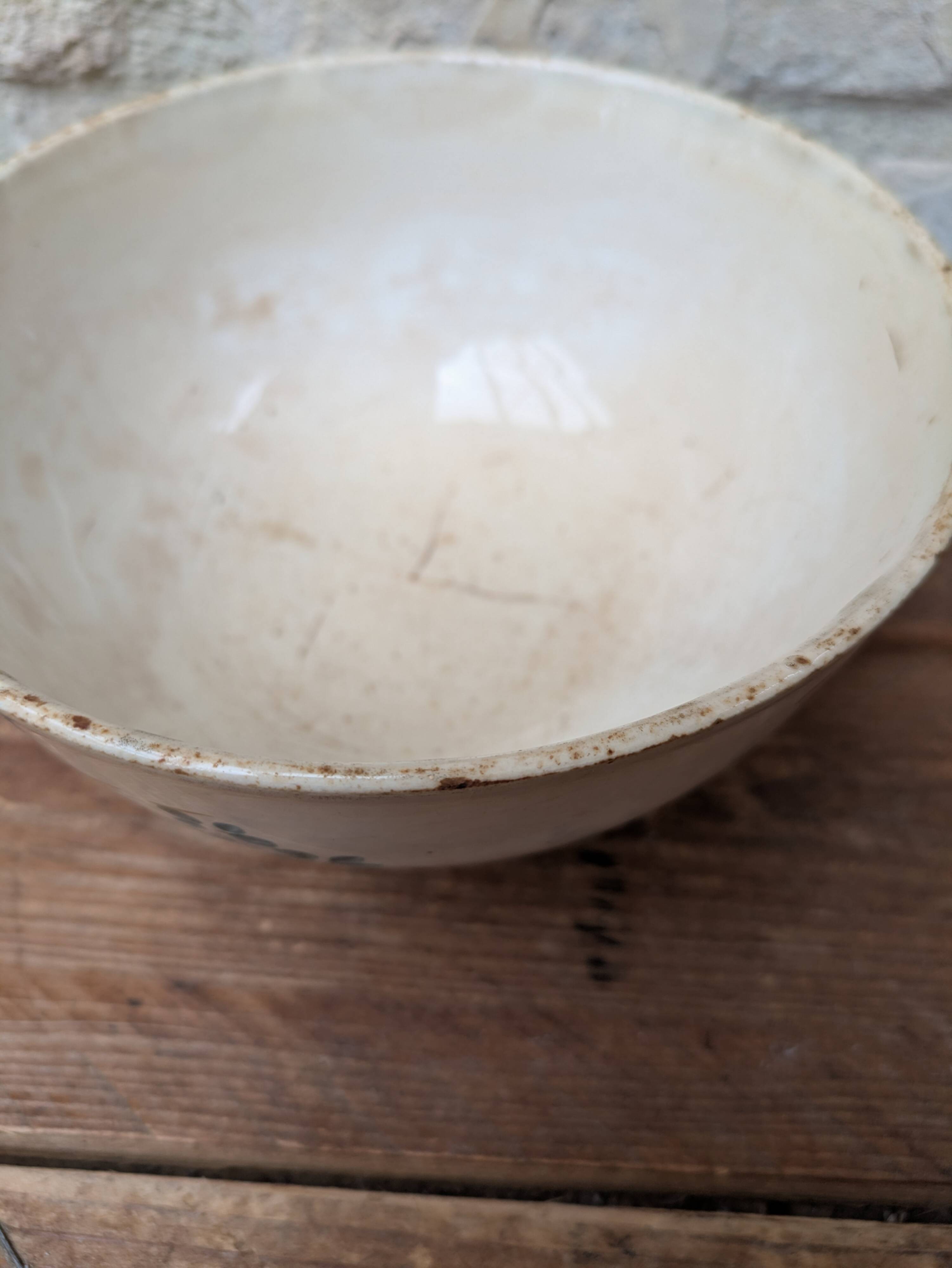 Old opaque porcelain bowl from Gien with a floral decoration.