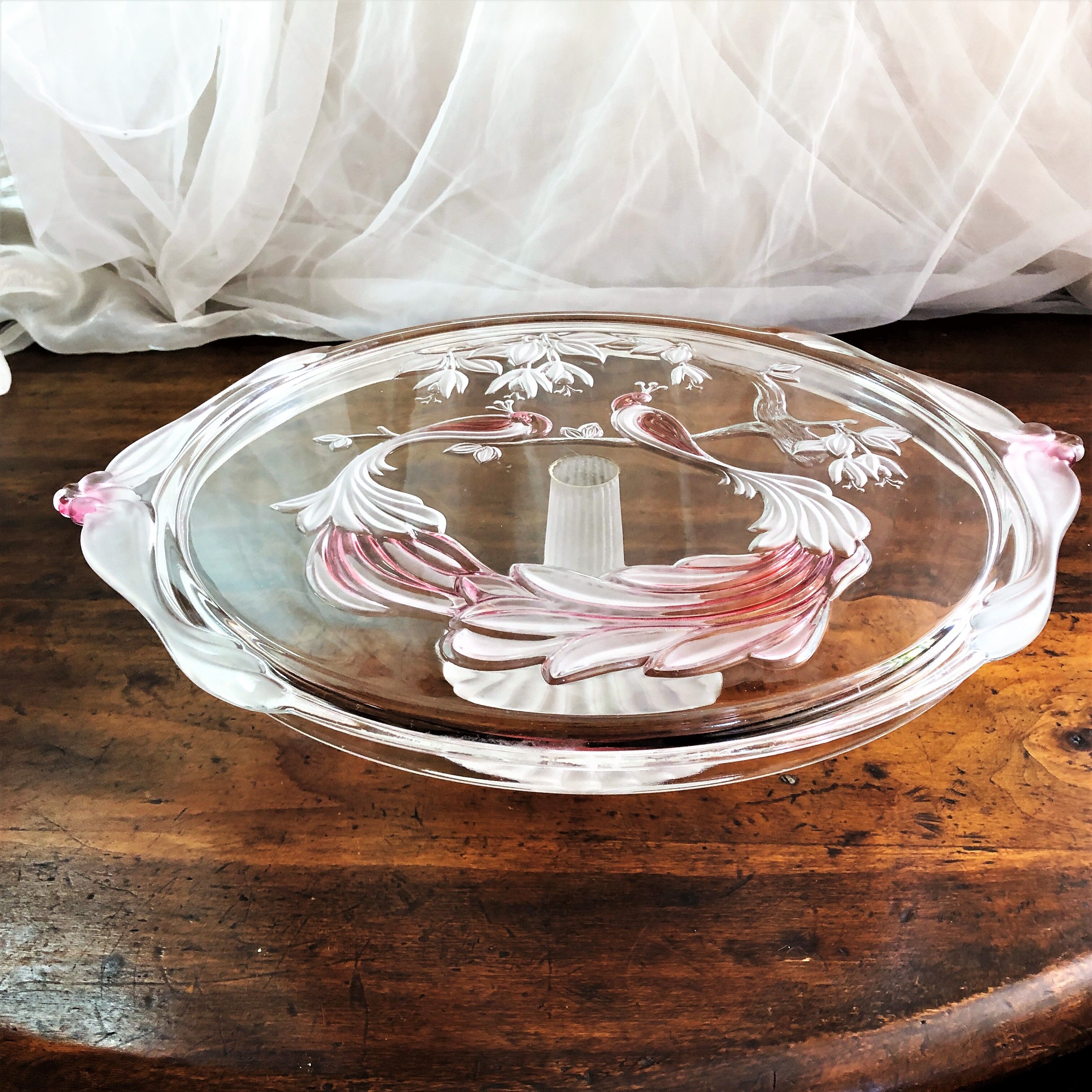 Large pie dish cakes on pedestal decorated with peacocks