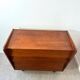 Vintage wooden chest of drawers with tapered legs.