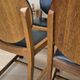 Set of four vintage wooden dining chairs with black leather upholstery