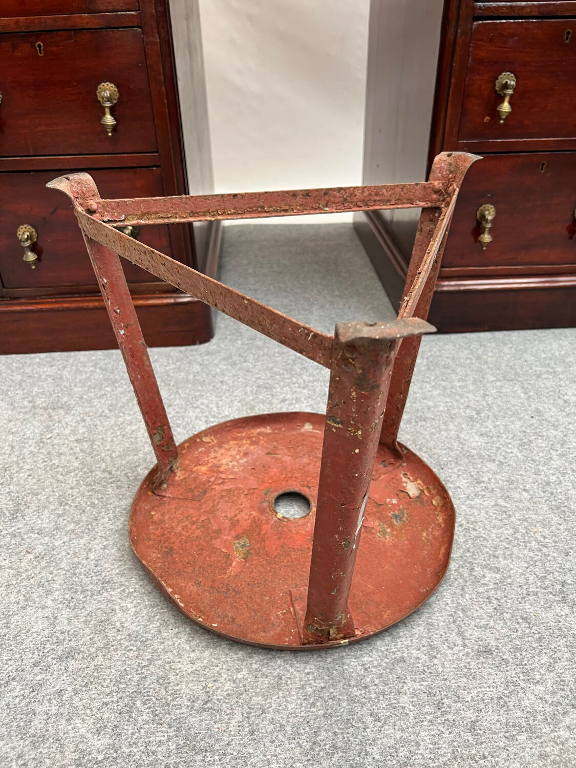 Red tripod industrial metal stool