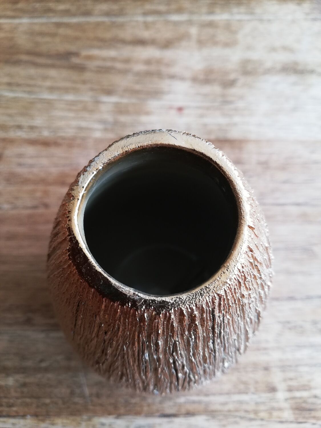 Small asymmetrical golden seed-shaped vase