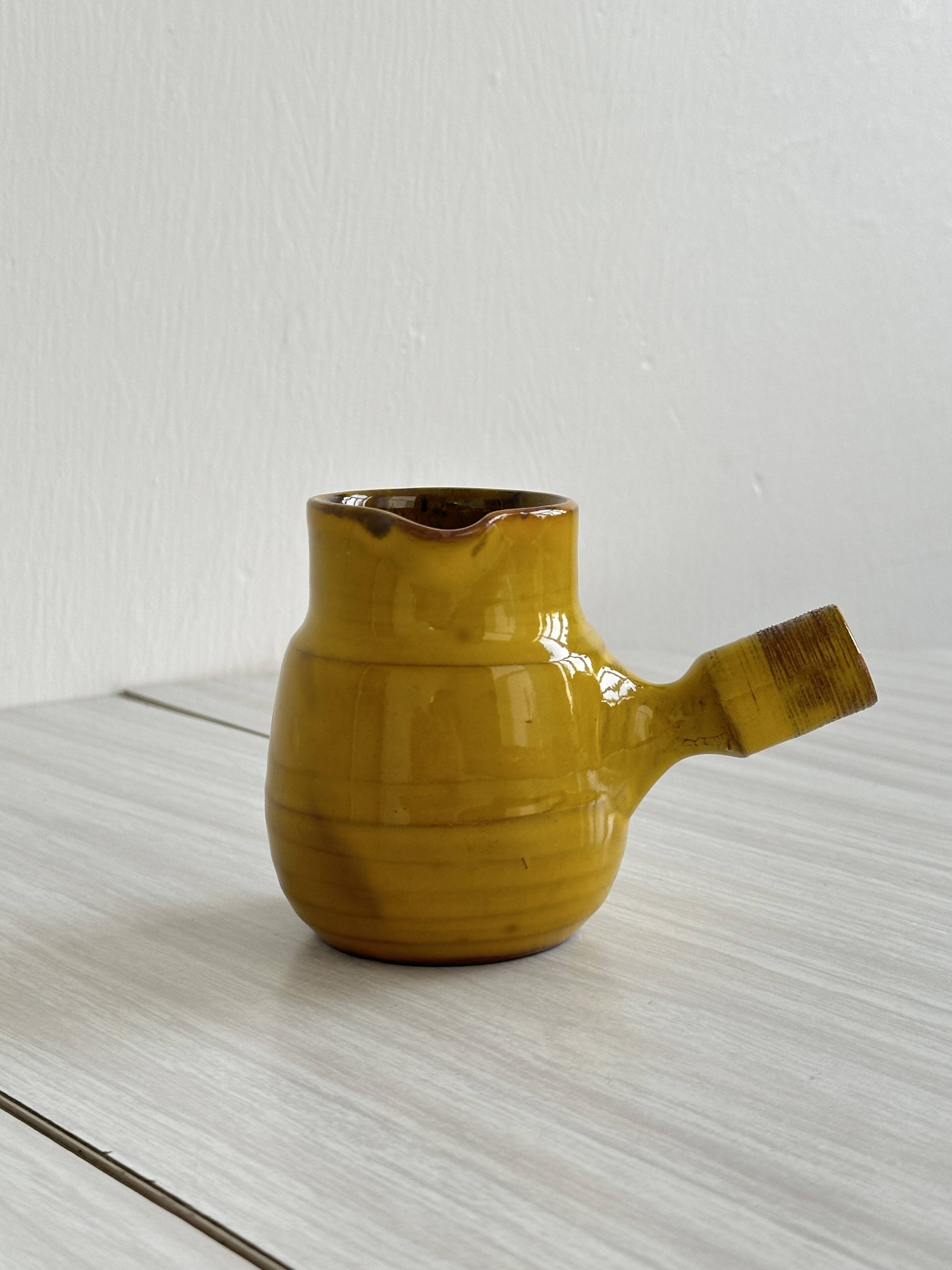 Yellow glazed ceramic sauce boat or milk jug
