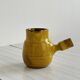 Yellow glazed ceramic sauce boat or milk jug