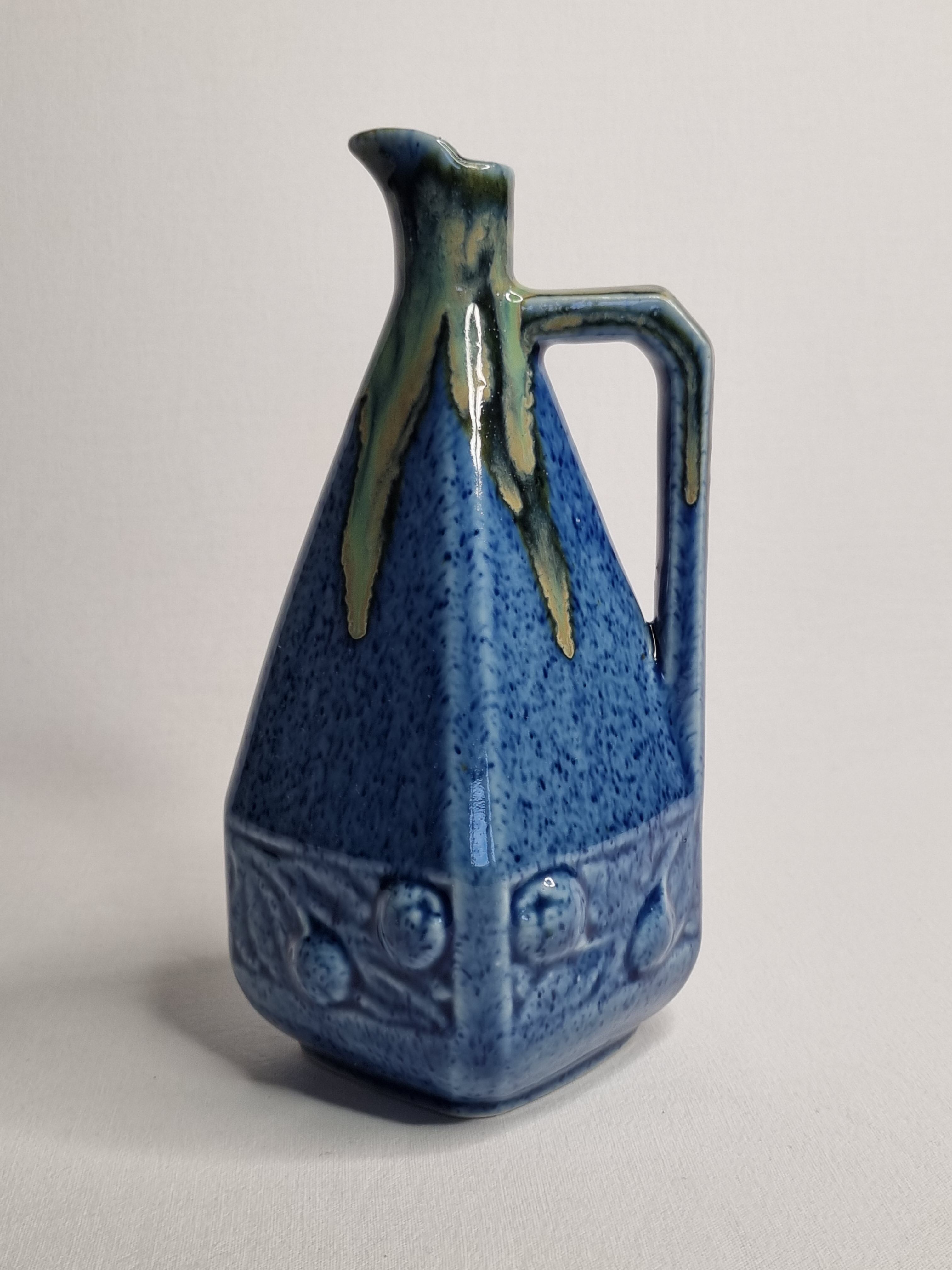 Art Deco pitcher in blue enamelled sandstone with fruit decoration, 22 cm
