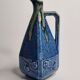 Art Deco pitcher in blue enamelled sandstone with fruit decoration, 22 cm