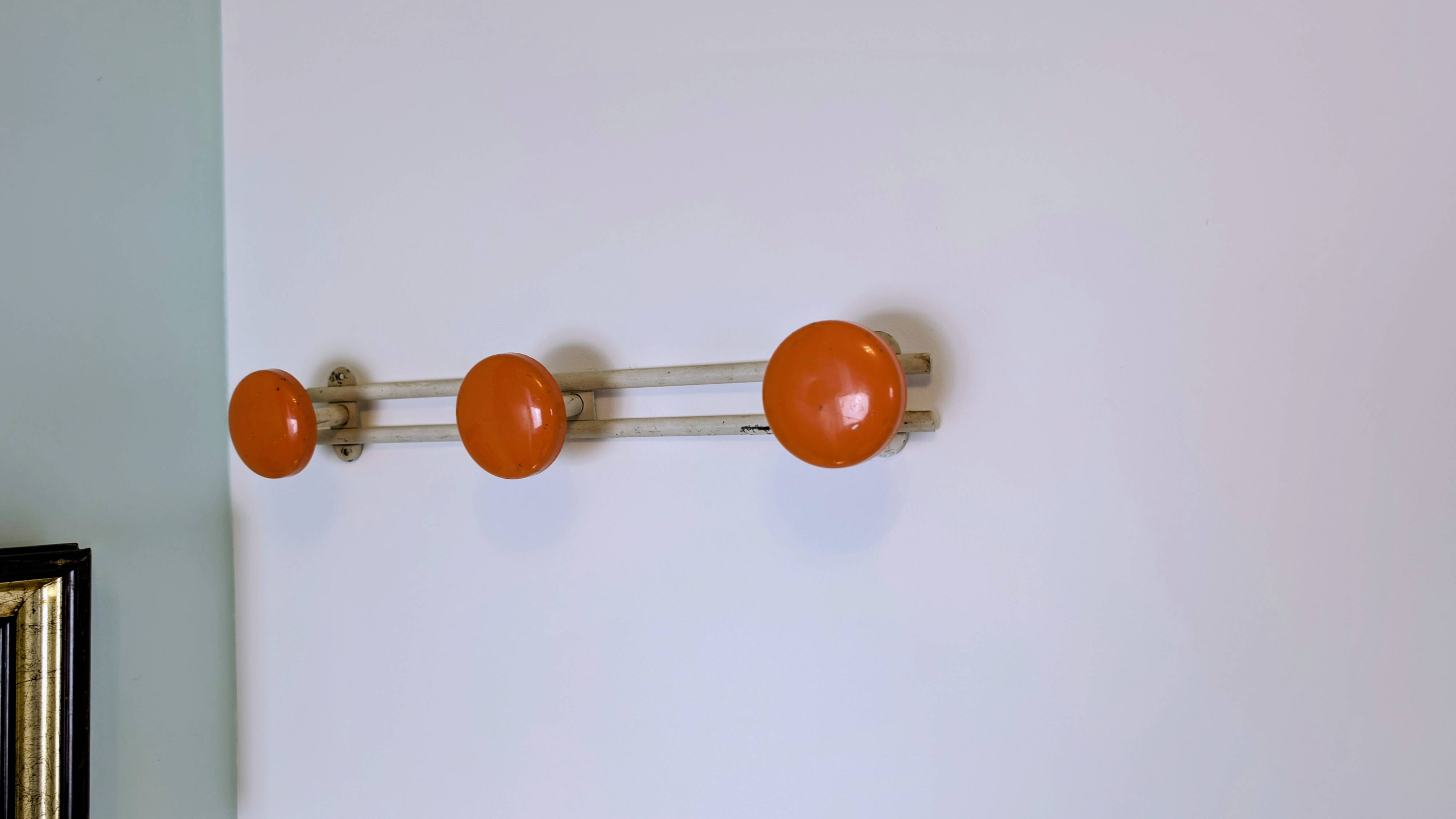 Vintage orange triple coat hook — metal and lacquered discs from the 60s/70s