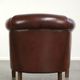 Characterful sheepskin club armchair in a dark cognac colour in English style
