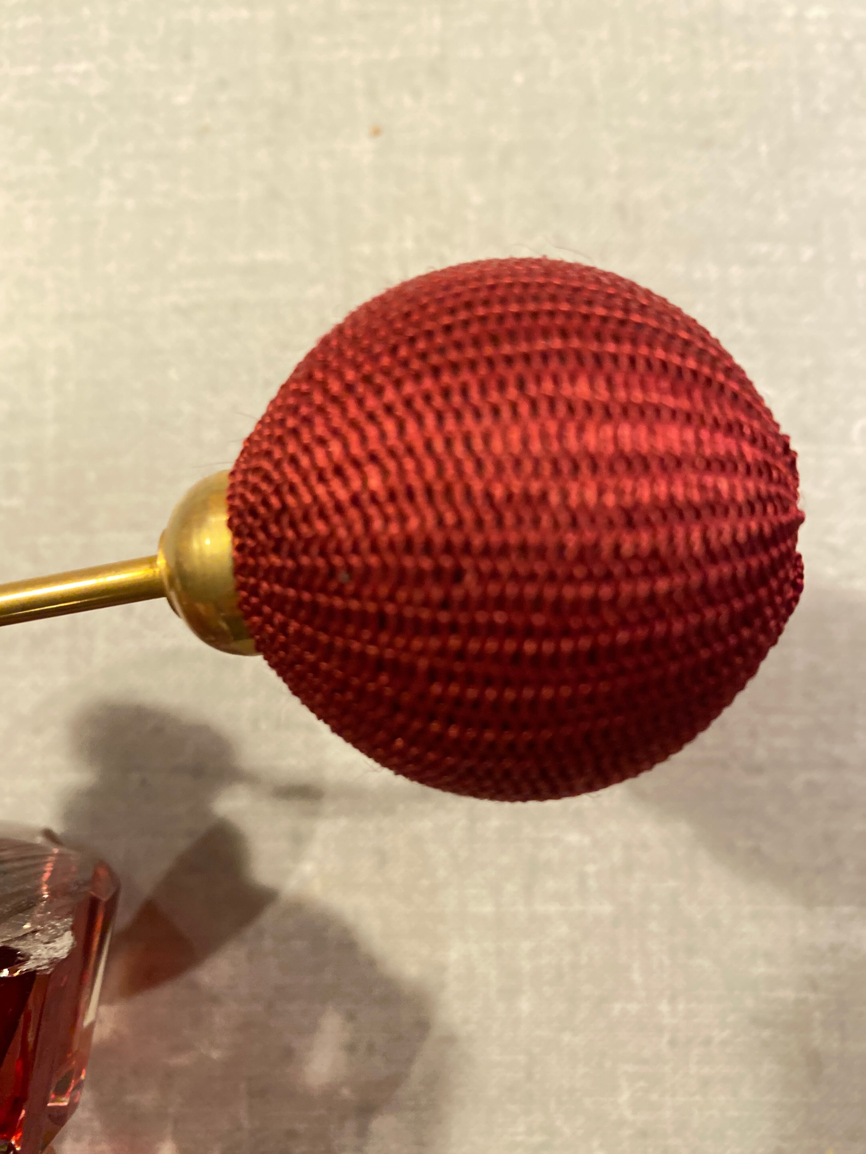 Red crystal perfume spray and red pump.